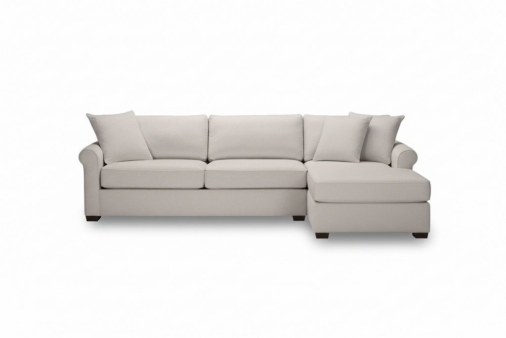 Beige sofa with two cushions on a white background
