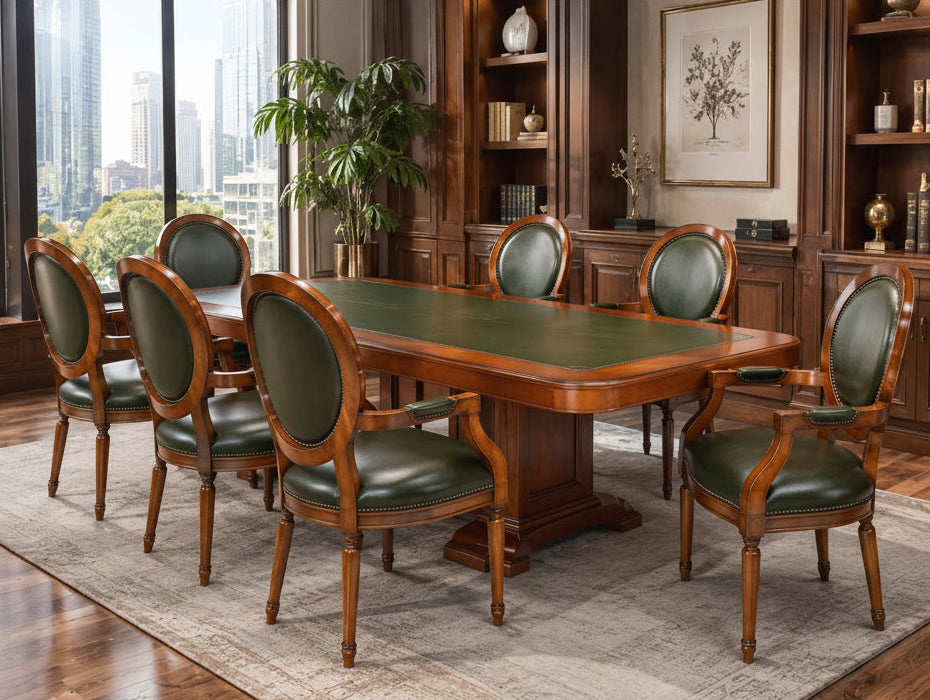 A 9-piece wooden dining room set including a rectangular table with a green leather top and eight matching armchairs with green leather upholstery, shown in a luxury modern office setting.