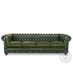 Green leather sofa with tufted backrest on a white background